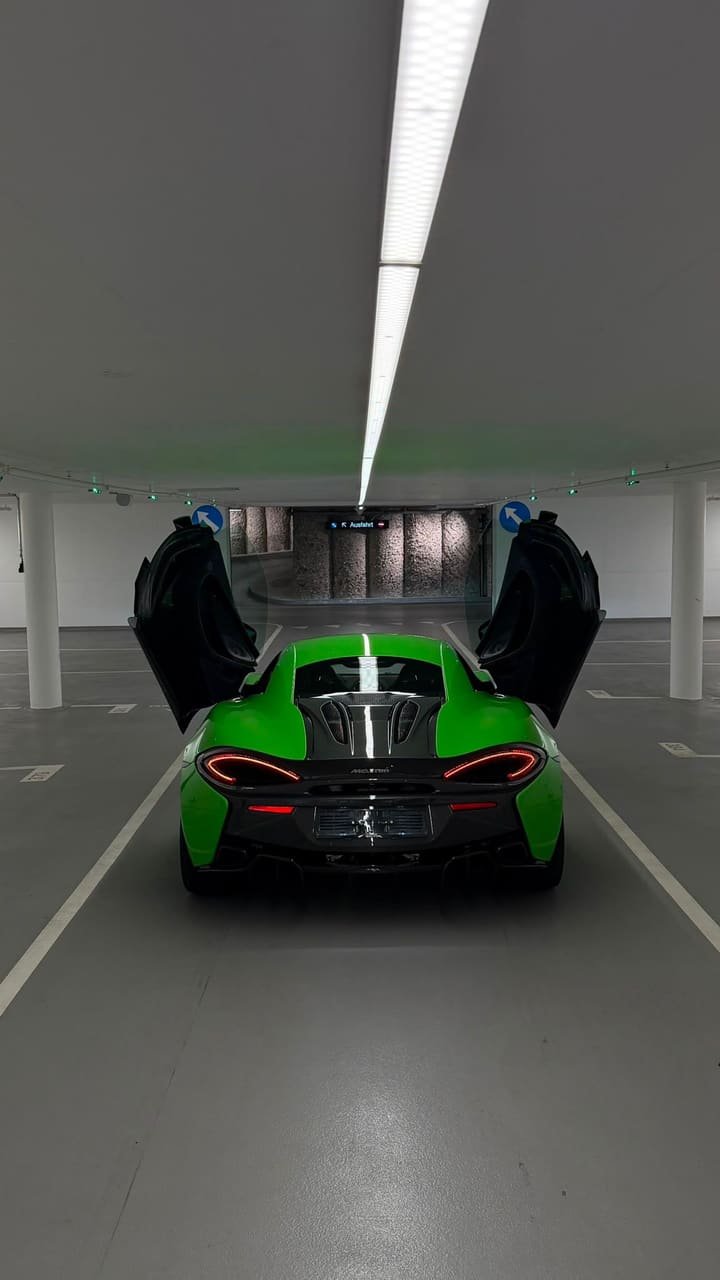 Rear of the McLaren 570S with LED tail lights, carbon engine cover and doors open